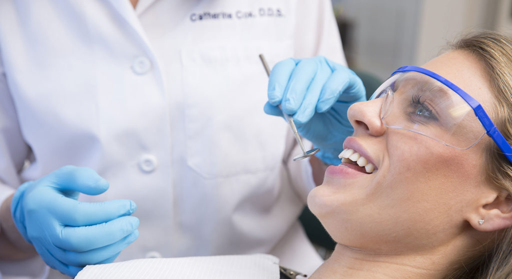 Dentist Examining a Patient With Mirror