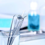 Teeth Cleaning Tools Standing Up In A Plastic Container in Dental Exam Room
