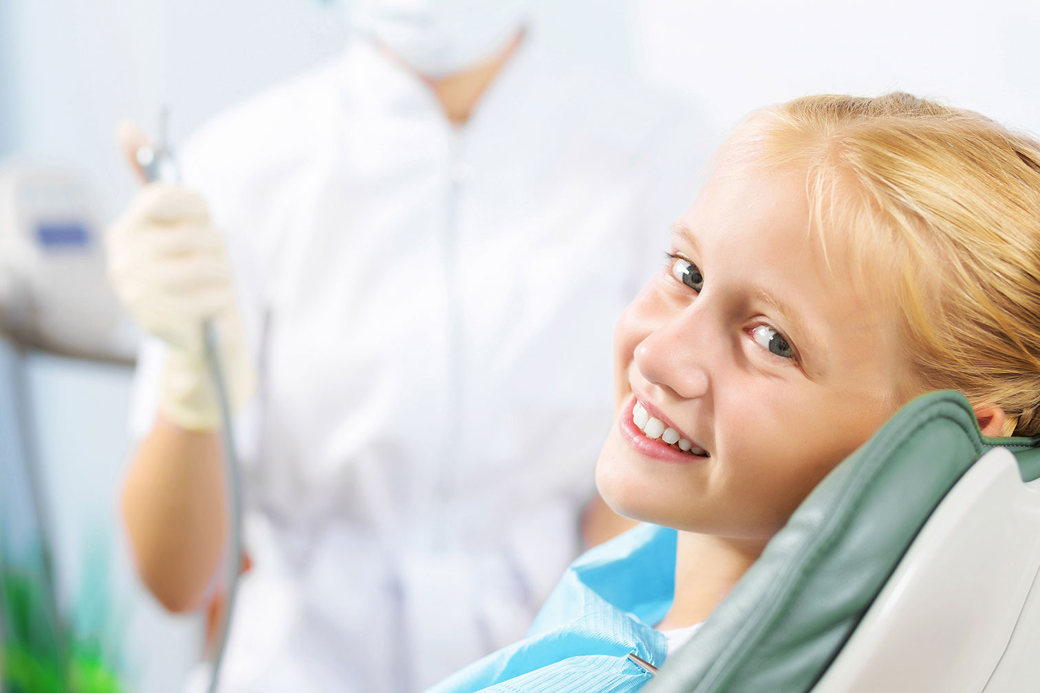10 Year Old Blond Girl in Dental Exam Chair Smiling