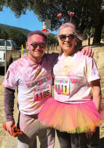 Dr. Catherine Cox celebrating at the Finish Line of the Marin 5k Color Run that supports local charities