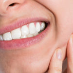 Combat Sensitive Teeth See Your Dentist - Woman Holding Sore Jaw